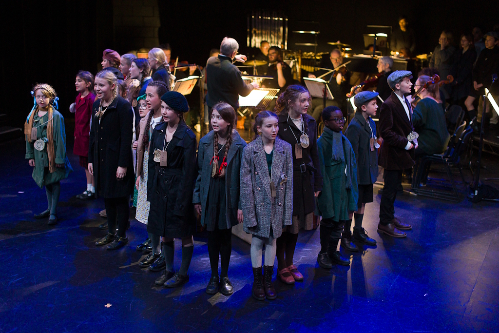 Photo showing some of the cast performing at the 10th anniversary performance of The Last Train by Carl Davis, performed at the Minerva Theatre, Chichester in January 2025. Photo credit - Dan Stevens
